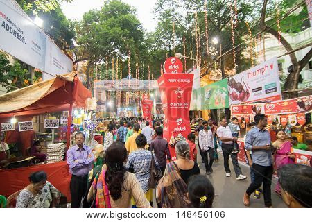 KOLKATA INDIA - OCTOBER 21 2015 : Crowd enjoying Durga Puja festival on road at Kolkata West Bengal India. Durga Puja is biggest religious festival of Hinduism.