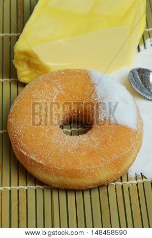 sweet donut with a lot of sugar on bamboo mat