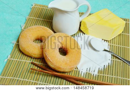 donut with milk butter and sugar on bamboo mat