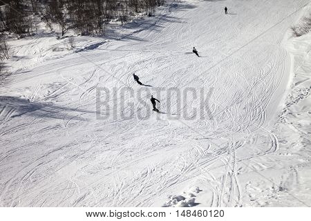 Skiers And Snowboarders On Ski Slope At Sun Winter Day