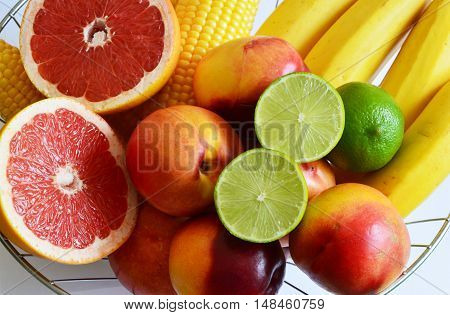 lime corn and colorful fruits in metal basket