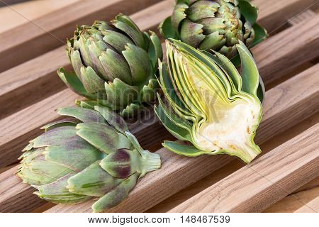Ripe Organic Artichokes On The Wooden Lattice