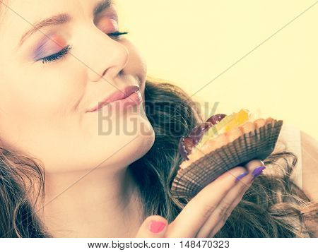 Woman Closed Eyes Holds Cake In Hand