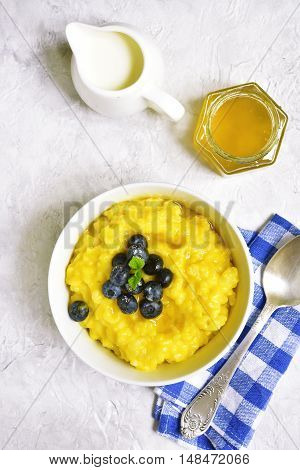Rice Porridge With Pumpkin And Fresh Blueberry.top View.