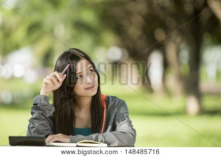 Young asian woman with smiley face in park