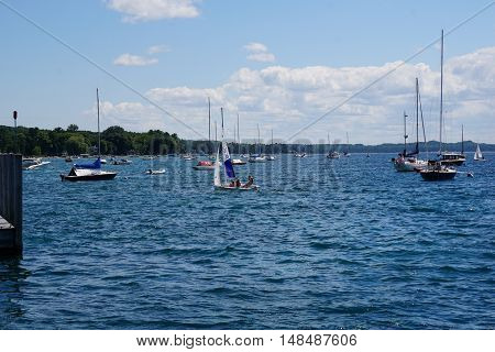HARBOR SPRINGS, MICHIGAN / UNITED STATES - AUGUST 1, 2016: People enjoy a sailing lesson, provided by Little Traverse Sailors, near the Harbor Springs Yacht Basin.