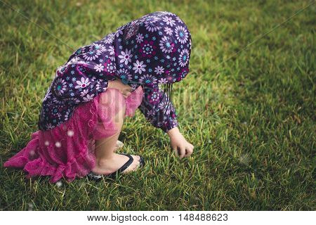 A young girl is feeling hail for the first time after a massive storm.