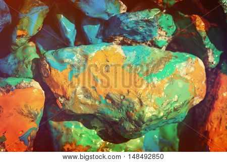 Bright abstract background. Stones painted with paint close