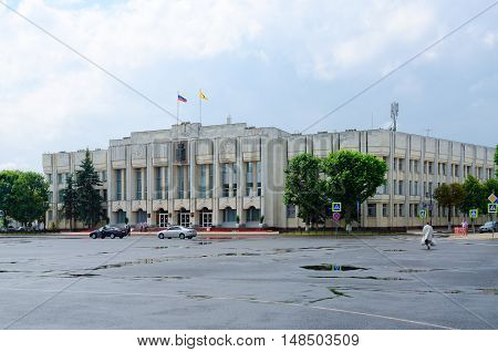YAROSLAVL RUSSIA - JULY 21 2016: Unidentified people go on Sovetskaya Square near administrative building (former building of Regional Committee of CPSU) Yaroslavl Russia