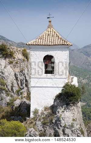 Belfry on the peak of the mountain. This tower belongs to Alcozaiba fortress built by muslims at XI century. Picture taken in El Castell de Guadalest Alicante Spain.