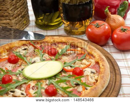 Whole Italian Pizza On Table With Ingredients