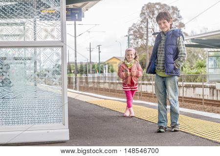 kids on railway station waiting for train
