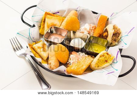 Tasting dish with venezuelan typical food .