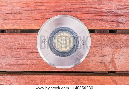 Construction details : closed up view of LED uplight installed on wooden deck