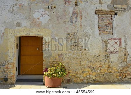 An old wooden door in Valvasone in Friuli Venezia Giulia north east Italy.