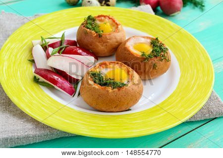Baked small flavorful bun with bacon cheese quail egg and greens. Tasty breakfast.