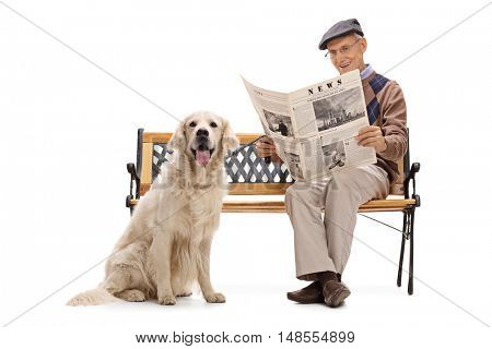 Elderly man sitting on a bench wth his dog and reading a newspaper isolated on white background.