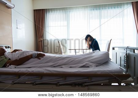 Women strain and worried for her friend in bed health condition in hospital room select focus