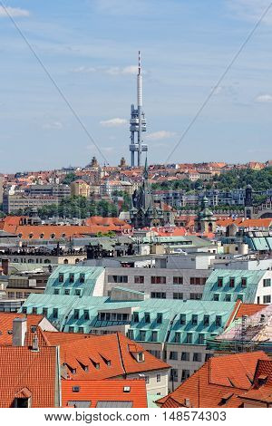 Aerial view of the traditional red roofs of the city of Prague Czech Republic with the Television tower in the distance. With its 216 m in height it's the tallest building in the city.