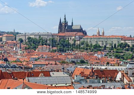 Aerial view of the traditional red roofs of the city of Prague Czech Republic with the Prague Castle - Hradcany in the background.