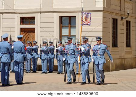 PRAGUE CZECH REPUBLIC - JULY 4 2014: Castle guards (Hradni straz) of presidential palace during ceremonial changing of guards. It takes place daily at noon accompanied by a brass band.