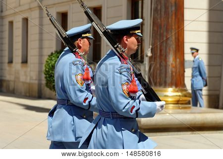 PRAGUE CZECH REPUBLIC - JULY 4 2014: Castle guards (Hradni straz) of presidential palace during ceremonial changing of guards. It takes place daily at noon accompanied by a brass band.