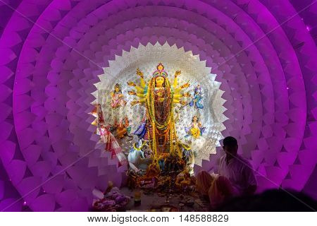 KOLKATA INDIA - OCTOBER 18 2015 : Night image of decorated Durga Puja pandal shot at colored light at Kolkata West Bengal India. Durga Puja is biggest religious festival of Hinduism.