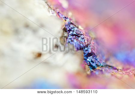 Bornite ore crystallizes mineral its blurred natural background. Macro. Focus on the central. Very shallow depth of field