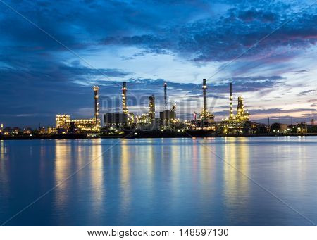 Oil refinery along Chao Phraya river at dusk Bangkok, Thailand