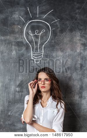 Young Smart Woman In Eyeglasses With Idea Symbol Bulb