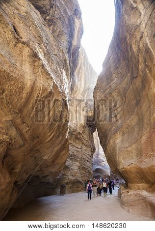 PETRA JORDAN - OCTOBER 29 2014: Unidentified tourists in the Siq - natural narrow passageway to Petra