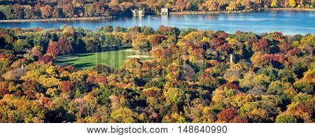 Panoramic aerial view of Central Park, Jacqueline Kennedy Onassis Reservoir and the Great Lawn with colorful Fall foliage. New York City.