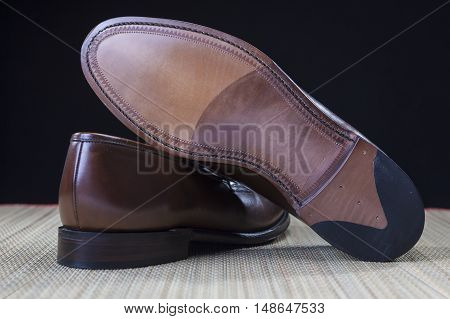 Footwear Concepts and Ideas. Backside View of Penny Loafer Natural Leather Sole. Horizontal Image Orientation