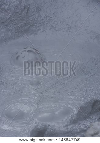 Geothermal landscape Hverarond on Iceland with boiling mud pit with steam.