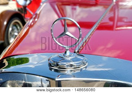 Kharkiv Ukraine - May 22 2016: Close up of the hood ornament of retro car red Mercedes-Benz Cabriolet manufactured in 1934 is presented at the festival of vintage cars Kharkiv Retro Rally - 2016 in Kharkiv Ukraine on May 22 2016