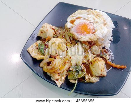 Stir Fried Mixed Vegetables With Roasted Chili Paste , Fried Egg & Thai Jasmine Rice On Black Dish.