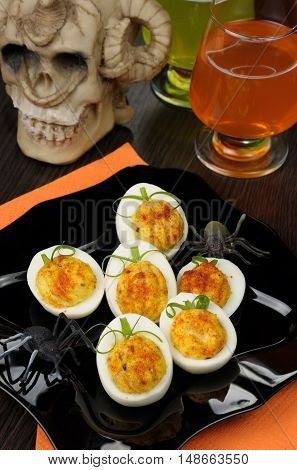 Stuffed eggs in the form of a pumpkin on the holiday table in honor of Halloween