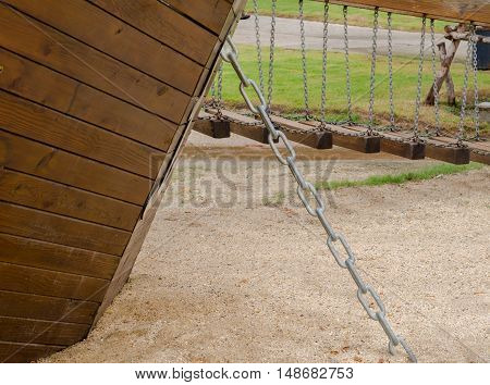 close-up, Reclaimed wood with chain. sandy soil.