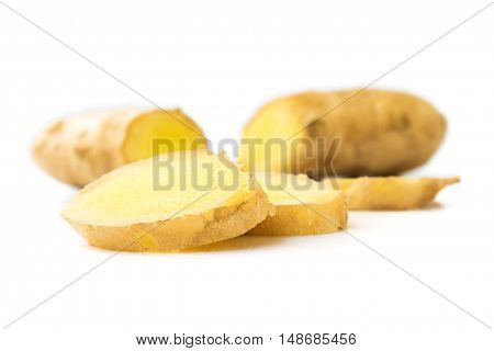 Fresh ginger on white background raw material for cooking selective focus