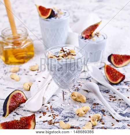 Dessert made with ricotta figs cashew nuts flax seed and honey. Selective focus.