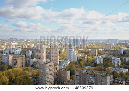 Panorama of the city with high-rise buildings and blue sky with clouds in autumn
