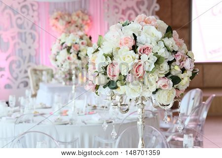 Beautiful bouquet of roses in wedding decor restaurant interior