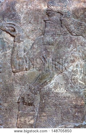 Standing Genie - ancient relief slab from a wall from the palace of King Assurnasirhpal II (883-889 B.C.) from Kalhu (Nimrud)