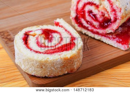 Sweet Roll With Jam On A Cutting Board.