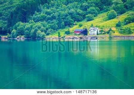 Norwegian Country Houses In The Mountains On Lake Shore
