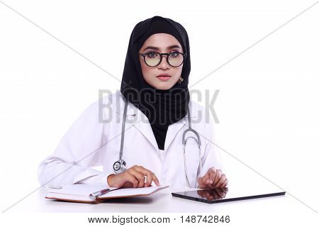 muslimah doctor holding a stethoscope isolated in white background