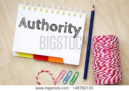 authority, text message on white paper and pencil on wood table / business concept