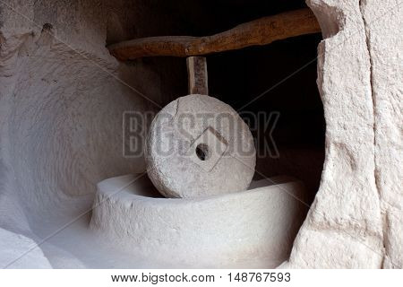 Ancient millstone in Zelve Valley in Cappadocia, Turkey. This process is being made by means of a stone 500 kg weight and 15 m. diameter moving by a rotation mechanism.