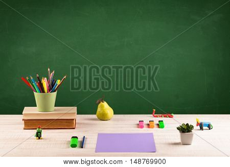 Back to school concepty with clear blackboard background, desk, items