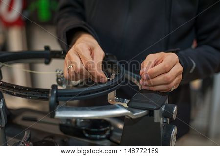 Close Up Of Tennis Stringer Hands Doing Racket Stringing